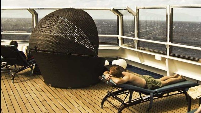 Serenity area features private sun pods for two Lounge chairs in Carnival Liberty's Serenity area